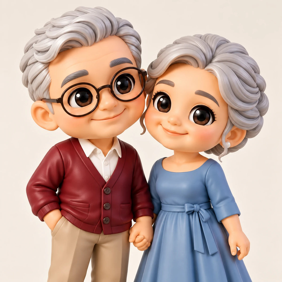 Vue rapprochée de deux figurines chibi aux cheveux argentés se tenant la main, avec lunettes rondes, cardigan bordeaux et robe bleue à nœud à la taille.